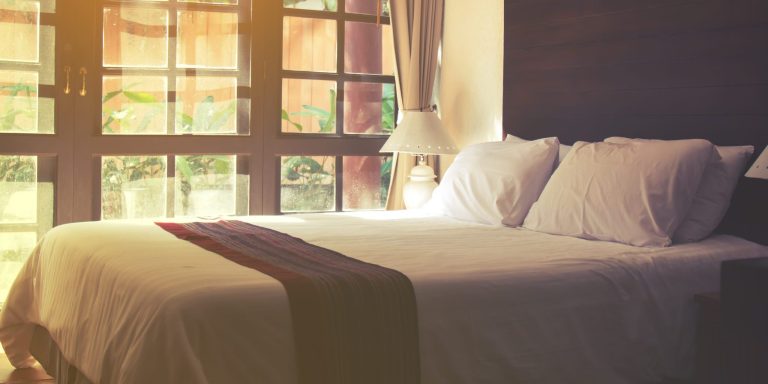 Bedroom luxury design and pillow in hotel. Selective focus and soft flare sunlight.
